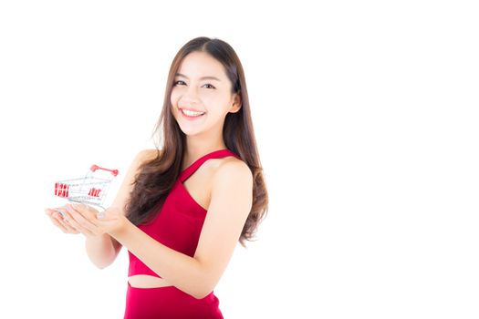 Smiling asian woman in red dress holding shopping cart with girl isolated on white background, shopping online concept.
