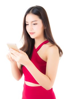 Beautiful asian young woman wear red dress using a mobile phone isolated on white background, communication concept.