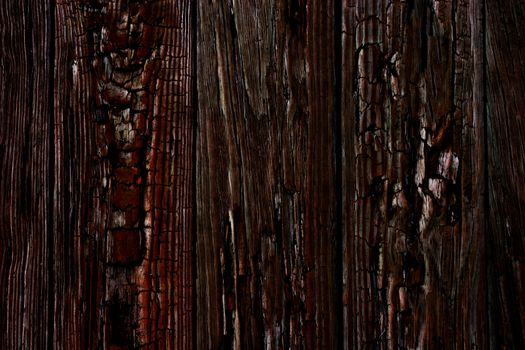 The texture of the charred planks of the walls of the house