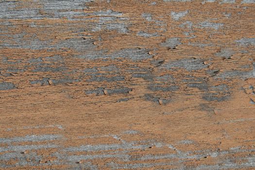 Flaky brown paint on the old wooden surface of the Board