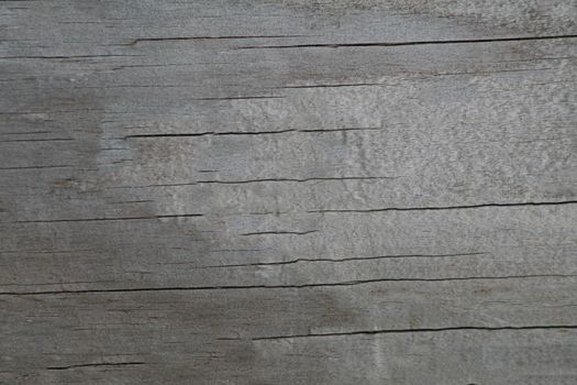 The old gray surface of the laminate with cracks simulated wood