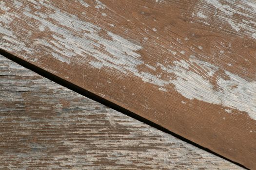 Peeling brown paint on an old wooden surface