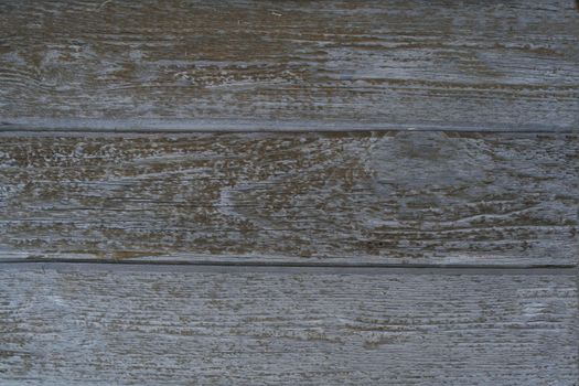 Old grey surface of wooden village fence with cracks