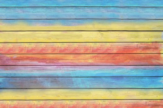 The fence of the old house is painted with colorful paints.Texture.Background.