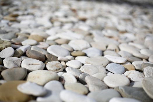 Out of focus pebbles on the beach closeup .Texture.Background.