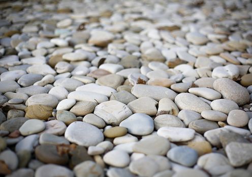 A large number of sea pebbles close-up on the coast is not in focus.Texture.Background.