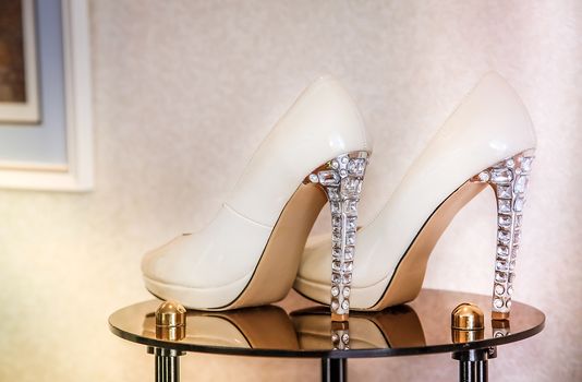 Wedding high-heeled shoes decorated with precious transparent stones