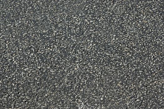 The asphalt road is dark gray with a rough surface.Texture or background.