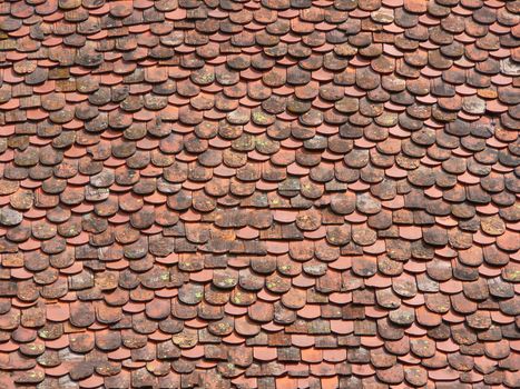 Old tile roof with a textured surface dirty orange color.Texture or background.