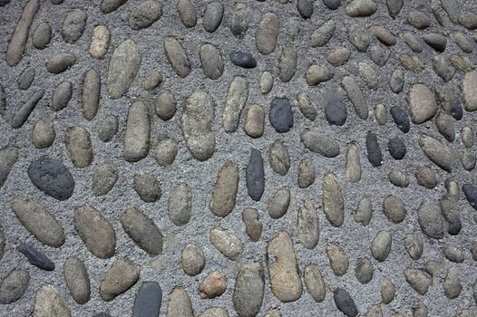 The wall is lined with stones oval shape.Texture or background.