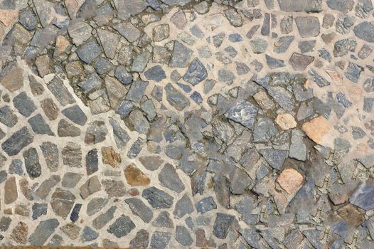 Old wall lined with pieces of stone of different sizes.Texture or background.