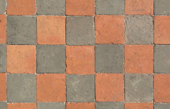 The floor is laid in a checkerboard pattern of square stone of different colors .Texture or background