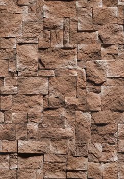 Decorative stone in the form of a sharp bumpy tile brown .Texture or background.