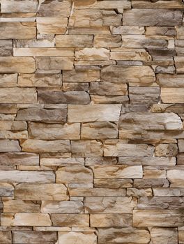 Decorative stone in the form of a sharp bumpy coffee-colored tile .Texture or background.