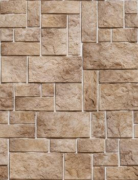 Decorative stone in the form of a sharp bumpy coffee-colored tile.Texture or background.