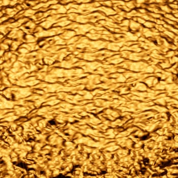 Heavily crumpled gold-colored metal sheet.Texture or background.