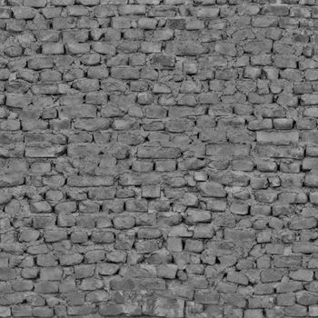 The wall of the abandoned building is made of dark gray bricks .Texture or background