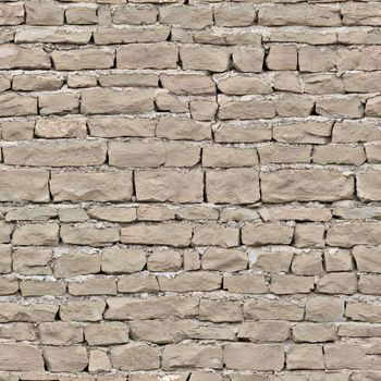 The cracked old wall of the building is lined with coffee-colored brick.Texture or background