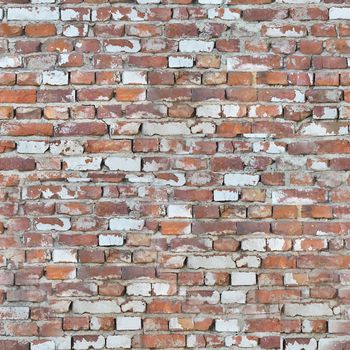 The cracked old wall of the building is made of red brick.Texture or background