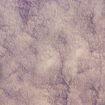 Rough uneven wall with a textured surface of purple color.Texture or background