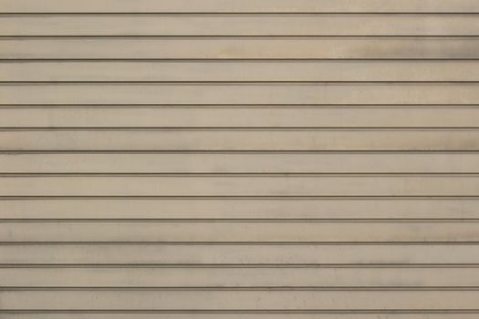 The facade of the house is laid out horizontally boards beige gray.Texture or background