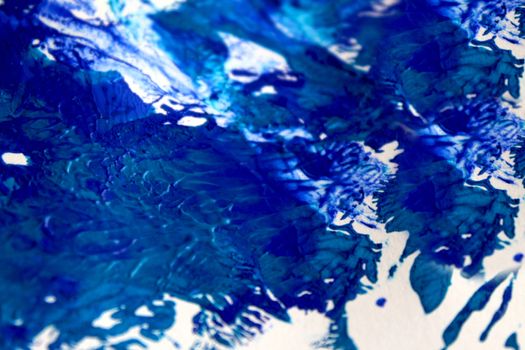 Smeared blue paint on white paper background or texture