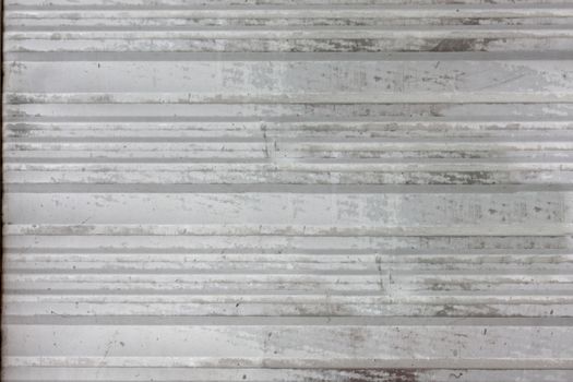 Old dark grey metal plate with horizontal stripes