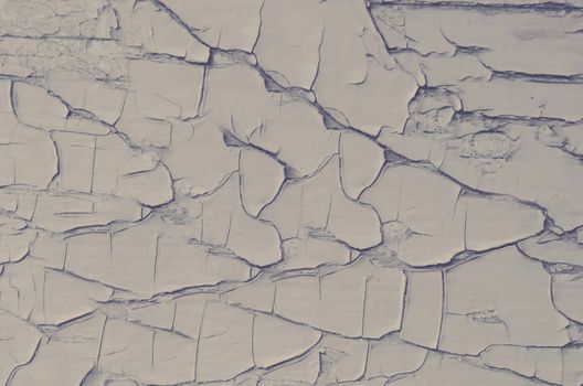 Cracked gray paint close-up on the surface