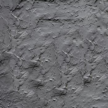 Uneven dark gray plaster applied to the wall surface