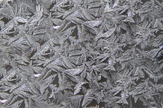 Frosty pattern on the surface of the window .Texture or background