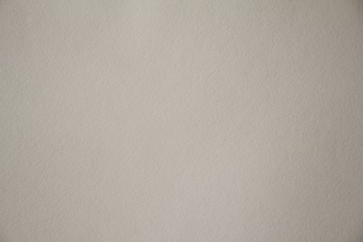 Sheet of dense cardboard with a textured surface of light brown color. Texture or background