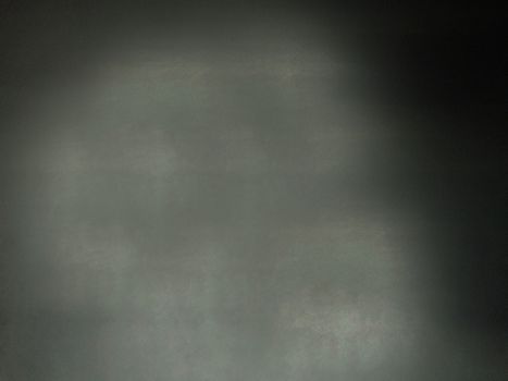 The wall is dark black with a rough textured blank surface.Texture or background.