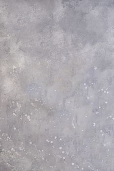 Grey wall with splashes on the surface of white acrylic paint .Texture or background.