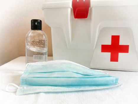 Prevention from the flu virus hand sanitizer and home first aid kit with a protective face mask