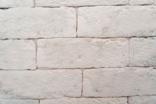 The wall is made of white rectangular blocks