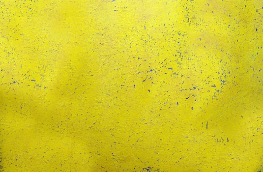 A wall with a textured, rough and scratched yellow surface.Texture or background