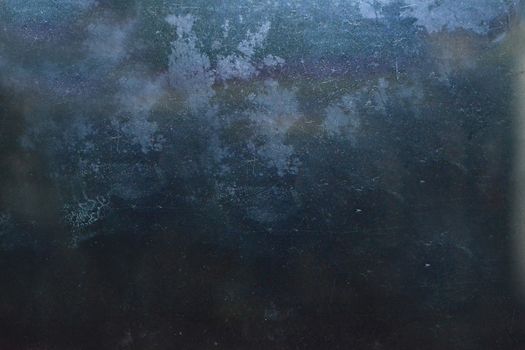 Dark blue background with scratches and lint on the surface