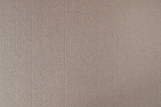 Pressed brown cardboard with a texture on the surface