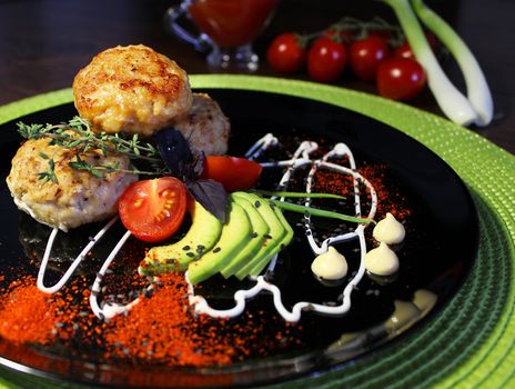 Culinary dish fried cutlets with cherry tomatoes and zucchini