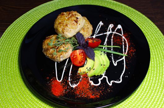 A beautifully designed dish of cutlets with seasoning herbs and zucchini