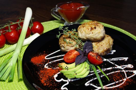 A dish of cutlets with seasoning and herbs with sliced zucchini