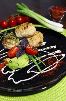 Culinary dish cutlets with cherry tomatoes and seasoning.Texture or background