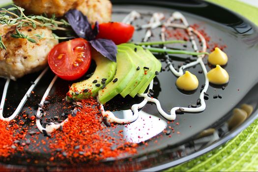 Sliced zucchini with cutlets is beautifully decorated with mayonnaise and herbs