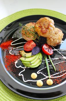 Zucchini with fried cutlets is beautifully decorated with mayonnaise and herbs