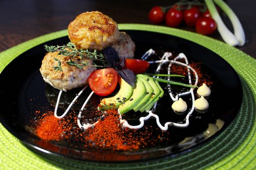 Homemade dishes with toasted cutlets with herbs and cherry tomatoes
