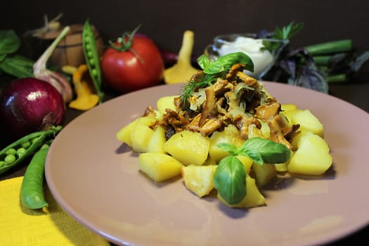 Hot dishes on the table with fried potatoes and mushrooms with herbs