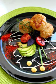 Culinary dish cutlets with cherry tomatoes and seasoning