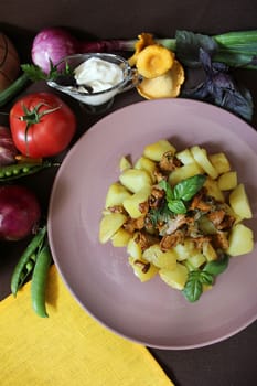 Country food fried potatoes with chanterelles and greens