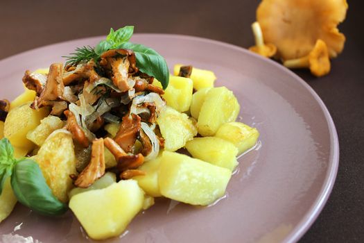 Hot dishes on the table with fried potatoes and mushrooms with herbs