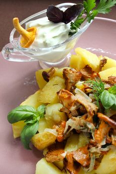Russian cuisine fried mushrooms with fried potatoes and herbs.Texture or background